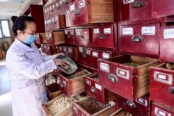 A medical worker fills a prescription of traditional Chinese medicine at a hospital in Shenyang in China's northeastern Liaoning province, Feb. 20, 2020. The toll in China from the coronavirus epidemic rose to 2,236, Feb. 21 after 118 more died.