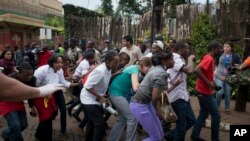 Civilians who had been hiding inside during the gun battle manage to flee from the Westgate Mall in Nairobi, Sept. 21, 2013.