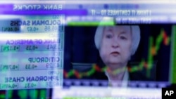 FILE - Federal Reserve Chair Janet Yellen is reflected in a specialist's screen on the floor of the New York Stock Exchange, June 15, 2016. 