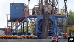 FILE - A crew works on a gas-drilling rig at a well site for shale-based natural gas in Zelienople, Pennsylvania, June 25, 2012. There has been a dramatic rise in earthquakes associated with wastewater from oil and gas drilling sites.