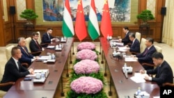 En esta foto difundida por la agencia de noticias Xinhua, el primer ministro húngaro Viktor Orbán, segundo desde la izquierda, conversa con el presidente chino Xi Jinping durante una reunión bilateral en Beijing, el lunes 8 de julio de 2024.
