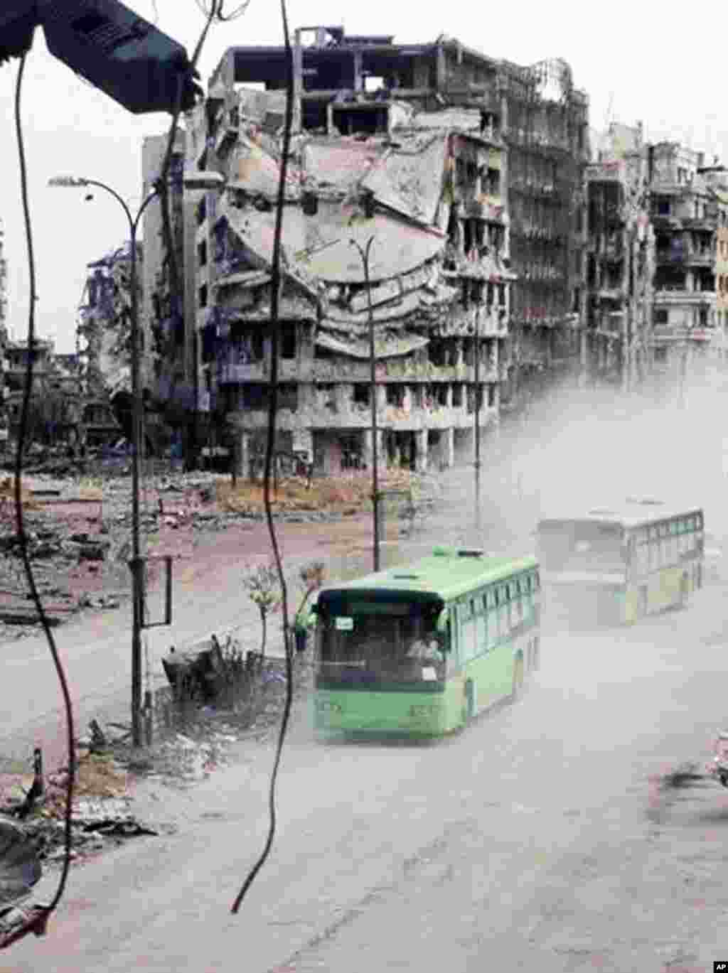 The exit of about 1,200 fighters and civilians marks a de facto end of the rebellion in the battered city of Homs, one of the first places to rise up against President Bashar al-Assad&#39;s rule, earning the nickname &quot;capital of the revolution,&quot; Homs, May 7, 2014.