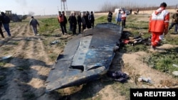 FILE - General view of the debris of the Ukraine International Airlines, flight PS752, Boeing 737-800 plane that crashed after take-off from Iran's Imam Khomeini airport, on the outskirts of Tehran, Jan. 8, 2020.