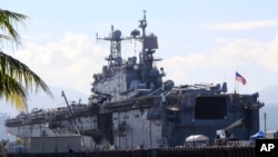 FILE - The amphibious assault ship USS Peleliu is seen docked following joint exercises at the Alava pier, off Subic Bay Freeport zone, northwestern Philippines, Oct. 13, 2014, as part of the Visiting Forces Agreement.
