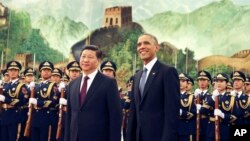 Chinese President Xi Jinping and U.S. President Obama take part in a welcome ceremony at the Great Hall of the People in Beijing in 2014. The pending sanctions might cool relations when Mr. Xi makes his first state visit to the U.S. (AP Photo/Andy Wong)