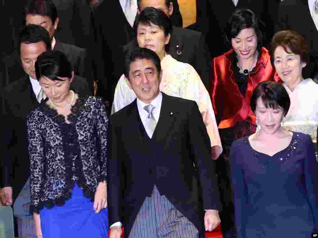 Japan's Prime Minister Shinzo Abe (front row center) and his new cabinet members gather for a photo session following the first cabinet meeting at the prime minister's official residence in Tokyo, Sept. 3, 2014.