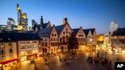 People walk at the Roemerberg square in central Frankfurt, Germany, Nov. 27, 2020. Christkindlesmarkt, one of Germany's best known holiday markets, was called off due to the coronavirus pandemic.