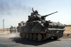 FILE - Turkish troops head to the Syrian border, in Karkamis, Turkey, Aug. 27, 2016.