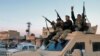 Members of the Syrian Democratic Forces deploy outside Ghwayran prison, also known as al-Sina'a, in Syria's northeastern city of Hasakah, Jan. 26, 2022, after retaking control of the facility from Islamic State group forces.