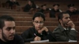 FILE - Mahinour el-Masry, an Egyptian activist, takes notes during a trial session of activists facing charges on organizing unauthorized protests, at a courtroom in Cairo, Egypt, Dec. 4, 2014..