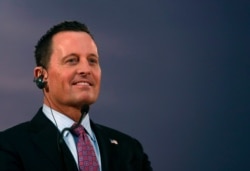 FILE - Ambassador Richard Grenell listens to Serbian President Aleksandar Vucic during a press conference after their meeting, in Belgrade, Serbia, Jan. 24, 2020.