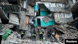 Rescuers work at a residential building hit by a Russian drone strike in the town of Hlukhiv, Sumy region, in this handout picture released Nov. 19, 2024. (Press service of the State Emergency Service of Ukraine in Sumy region/Handout via Reuters)