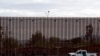 In this April 5, 2019, photo, a U.S. Customs and Border Protection vehicle sits near the a section of the U.S. border wall with Mexico in Calexico, Calif. 