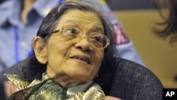 In this photo taken on OctOBER 19, 2011 and released by the Extraordinary Chambers in the Courts of Cambodia, Ieng Thirith smiles during a hearing in Phnom Penh.