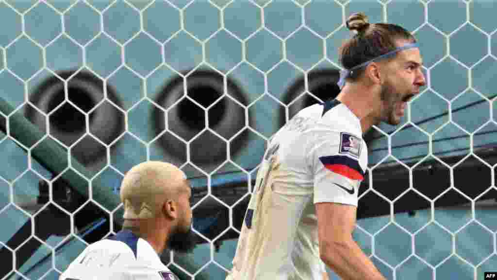 Défenseur ta Etats-Unis #22 DeAndre Ydlin (G) na défenseur mosusu ya Etats-Unis #30 Wlaker Zimmerman bazali kosepela nsima na momgete ya #19 Haji Wright (amonani te) na match ya 8e na Mondial Qatar 2022 na stade Khalifa, Doha, 3 décembre 2022. (Photo by