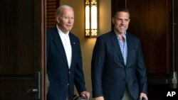 FILE - President Joe Biden and his son Hunter Biden are seen leaving a church service in Johns Island, South Carolina, Aug. 13, 2022, while on a family vacation in the area.