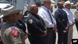 FILE - Uvalde School Police Chief Pete Arredondo, third from left, stands during a news conference outside of the Robb Elementary school in Uvalde, Texas, on May 26, 2022.