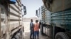 FILE - A member of the Ethiopia Federal Police inspect the cab of a truck at a security checkpoint where a truck aid convoy directed to Ethiopia's Tigray region is being inspected on the outskirts of Semera, Afar region, Ethiopia, May 15, 2022.