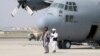 Taliban berjalan di depan pesawat militer sehari setelah penarikan pasukan AS dari Bandara Internasional Hamid Karzai di Kabul, Afghanistan 31 Agustus 2021. (Foto: Reuters)