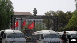 Tunisian police stand guard outside the parliament in Tunis on July 27, 2021.