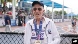 FILE - Richard Soller holds the medal he won in the 200 meter final at the National Senior Games, Monday, May 16, 2022, in Miramar, Fla. (AP Photo/Marta Lavandier)