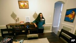 Charvi Goyal, 17, prepares to jump online for a tutoring session she gives to a junior high student from her family's home Monday, Jan. 4, 2021, in Plano, Texas. 