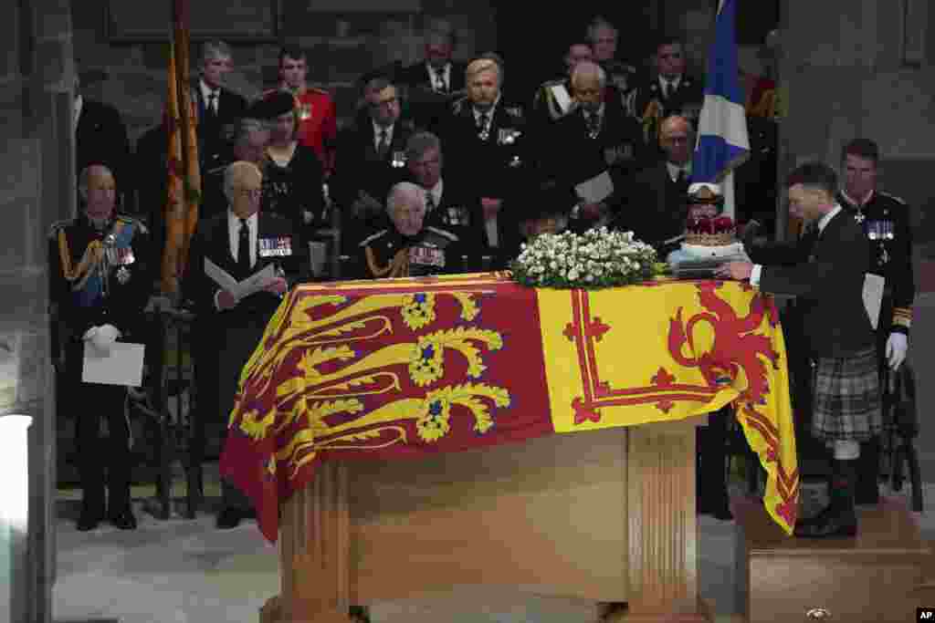 From left, Prince Edward, Prince Andrew, King Charles III, Camilla, the Queen Consort, Princess Anne and Vice Admiral Sir Tim Laurence, look on as the Duke of Hamilton places the Crown of Scotland on the coffin during the Service of Prayer and Reflection for the Life of Queen Elizabeth II at St. Giles' Cathedral, Edinburgh, Sept. 12, 2022.