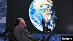 FILE - Physicist Stephen Hawking sits on stage during an announcement of the Starshot initiative with investor Yuri Milner in New York, April 12, 2016. A partnership was announced this week with the European Southern Observatory, which will use one of their telescopes to hunt for inhabitable planets. 