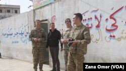 U.S. military and diplomatic delegations tour the city of Manbij, Syria, March 22, 2018.