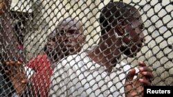 FILE - Prisoners line up inside Douala central prison in Cameroon.