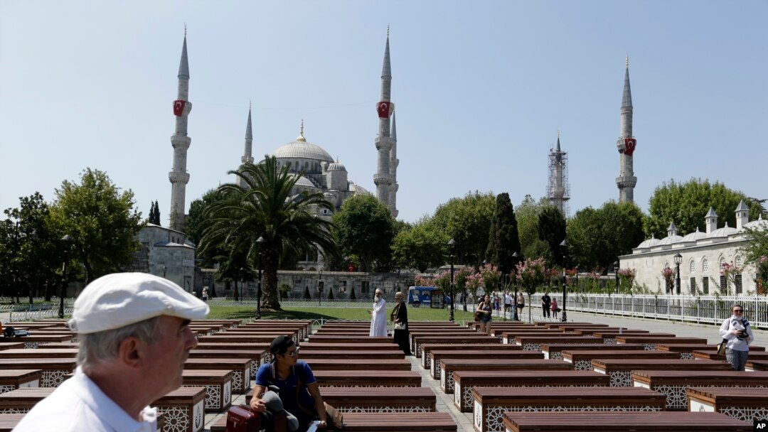 FILE - Tourists visit the Sultan Ahmed Mosque, also known as Blue Mosque, in Istanbul, Aug. 11, 2016. Tourism is a key sector and foreign-currency earner for Turkey, but numbers have dropped sharply as a result of a series of attacks in the country and an attempted coup in July.