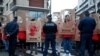 FILE - Members of Reporters Without Borders hold stencils representing portraits of imprisoned Turkish journalists, during a demonstration in front of the Turkish Embassy, in Paris, Jan. 5, 2018. 