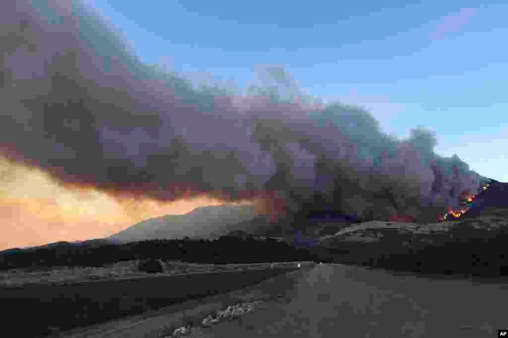 A wildfire burns off of the hills next to CA-126 highway, just northwest of Fillmore, California, Dec. 7, 2017.
