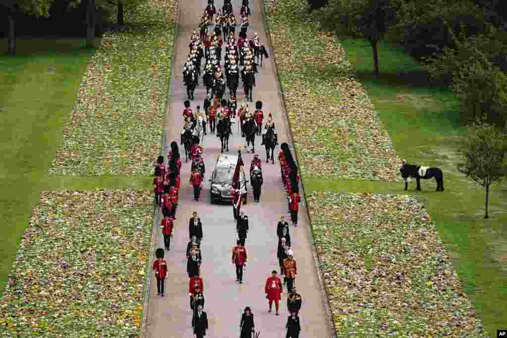 Emma, the monarch's fell pony, watches the Ceremonial Procession of the coffin of Queen Elizabeth arrives at Windsor Castle for the Committal Service at St. George's Chapel, Sept. 19, 2022.