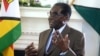 FILE - Zimbabwean President Robert Mugabe addresses his staff during a surprise birthday celebration event at State House in Harare, Feb. 22, 2016. Mugabe said Wednesday the country needs to rethink its indigenization policy. 