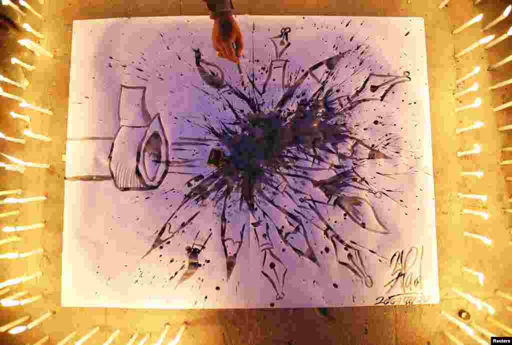 A journalist draws a cartoon during a candle light vigil organized by the Federation of Nepalese Journalists to pay tribute to victims of Wednesday's shooting by gunmen at the offices of French weekly newspaper Charlie Hebdo in Paris, in Kathmandu, Jan. 9, 2015.