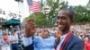 Alpha Saliou Diallo, a refugee from Guinea, holds his daughter, Aisha, after he became a U.S. citizen during a special naturalization ceremony commemorating World Refugee Day at the Delacorte Theater in New York City's Central Park, June 20, 2016.