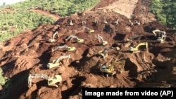 FILE - Excavators search for bodies in Hpakant, Kachin State, Myanmar, Nov. 24, 2015. Six people are feared dead in the same region after a landslide Monday.