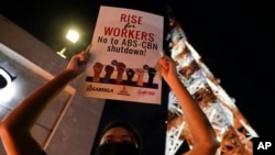 An activist holds a slogan outside the headquarters of broadcast network ABS-CBN corp. May 5, 2020 in Quezon city, Metro Manila, Philippines, expressing shock over the loss of a major news provider during the coronavirus pandemic.