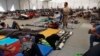 Migrant Caravan Detained in Old Factory, across from Texas