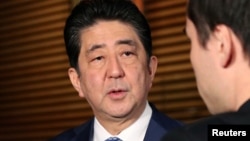 FILE - Japan's Prime Minister Shinzo Abe speaks to reporters about North Korea's missile launch, in Tokyo, Japan in this photo taken by Kyodo, Nov. 29, 2017.
