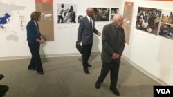 Former President Jimmy Carter and former first lady Rosalynn Carter tour the "Countdown to Zero" with Donald Hopkins, former director of Carter Center Health Programs, during a press event at the Jimmy Carter Library and Museum in Atlanta, Georgia, Jan. 11, 2017. (K. Farabaugh/VOA)