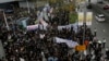 Journalists and their supporters gather outside government headquarters in Hong Kong, March 2, 2014, to protest the attack on a prominent former newspaper editor and to express support for freedom of the press.