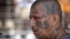 FILE - a gang member of MS-13 attends mass at a prison in Ciudad Barrios, El Salvador. MS-13, or the Mara Salvatrucha, is believed by federal prosecutors to have thousands of members across the U.S., primarily immigrants from Central America. 