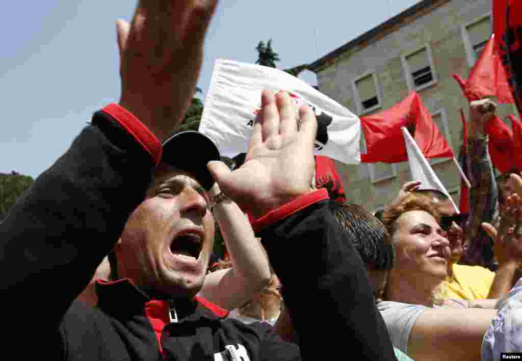 Supporters of the Albanian Red and Black Alliance party shout slogans during a May Day protest in front of the Albanian prime minister's office in Tirana, May 1, 2013.