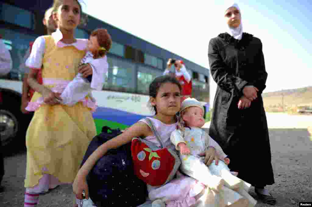 Girls that were evacuated from the besieged Damascus suburb of Daraya after an agreement was reached between rebels and Syria's army, arrive to a camp inside the government-controlled Herjalleh suburb of Damascus, Aug. 27, 2016.