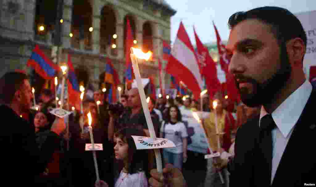 Demonstrators pass the State Opera during a torch-bearing march marking the centenary of the mass killing of Armenians by Ottoman Turks, in Vienna, April 24, 2015. An Austrian parliamentary declaration describes the killings as 'genocide', a term that the Austrian government had long rejected.