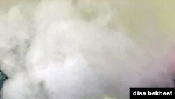 FILE- A man vapes with an electronic cigarette, exhales in Fair Oaks, Virginia. (Phot: Diaa Bekheet). A study suggests a possible link between vaping and COVID-19. 