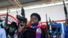 ARCHIVES - Le chef du gang "G9 et Famille", Jimmy Cherizier, plus connu sous le nom de Barbecue, dirige une marche contre les enlèvements, dans le quartier de La Saline à Port-au-Prince, Haïti, le 22 octobre 2021.