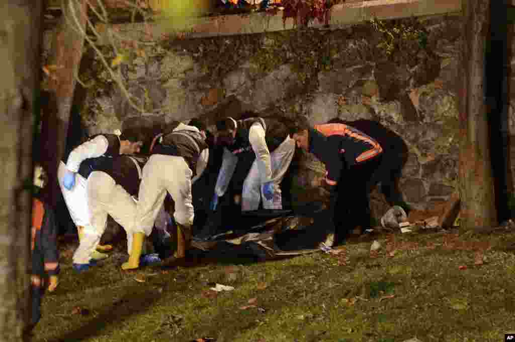 Forensic officials work at the scene of explosions near the Besiktas football club stadium after attacks in Istanbul, Dec. 10, 2016.